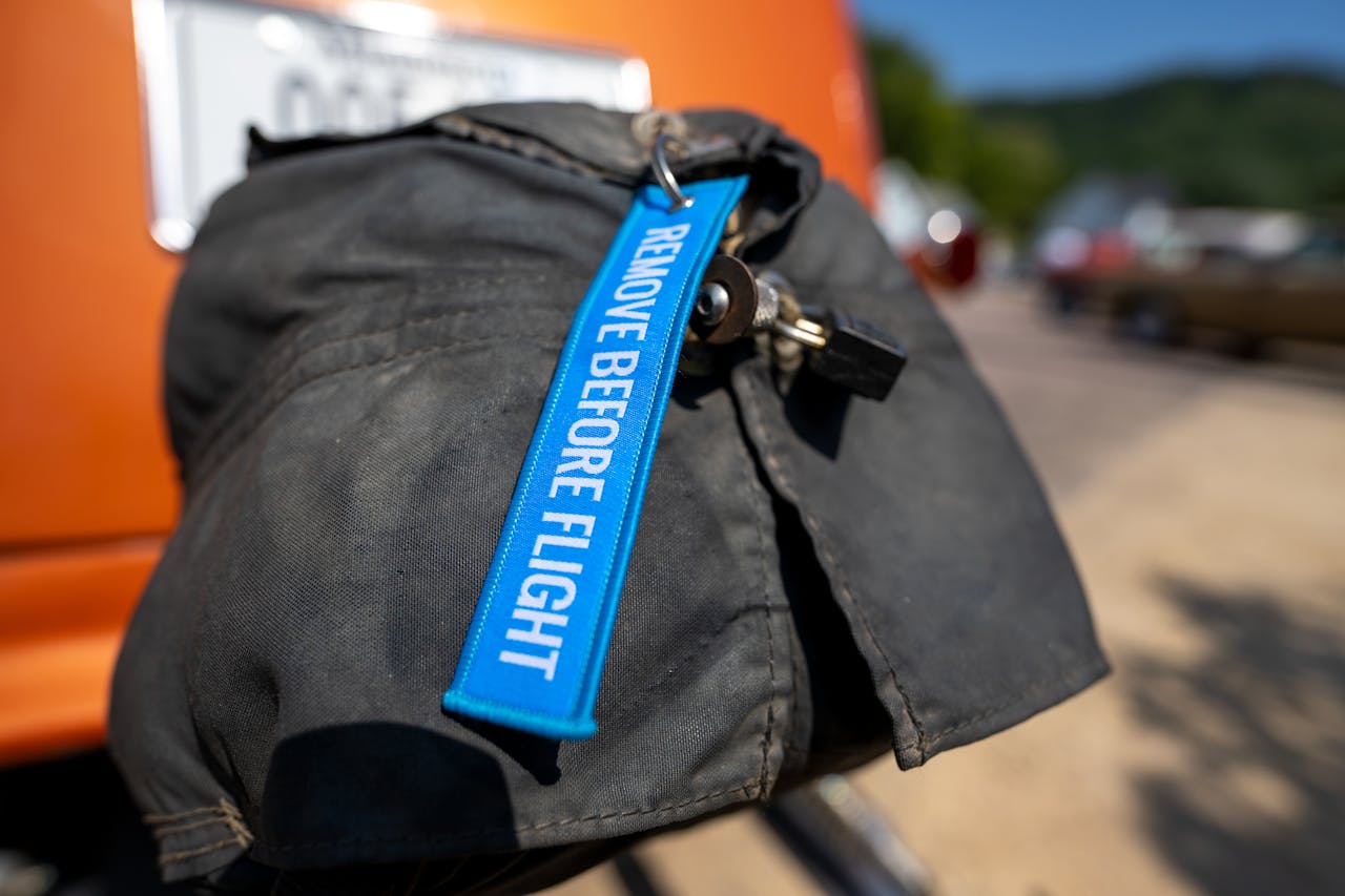 Bright blue 'remove before flight' tag on vehicle exhaust cover.